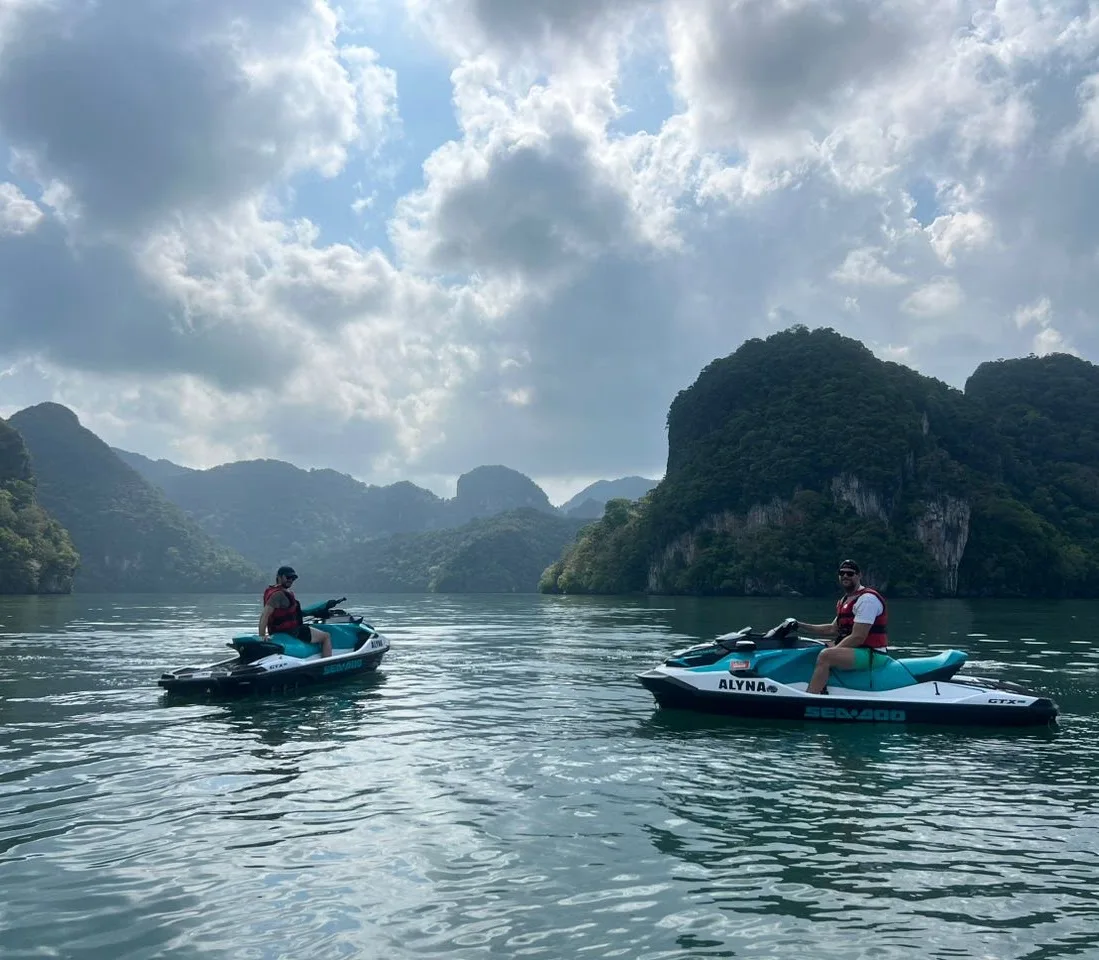 Two Alyna jet skis on calm water beneath limestone islands