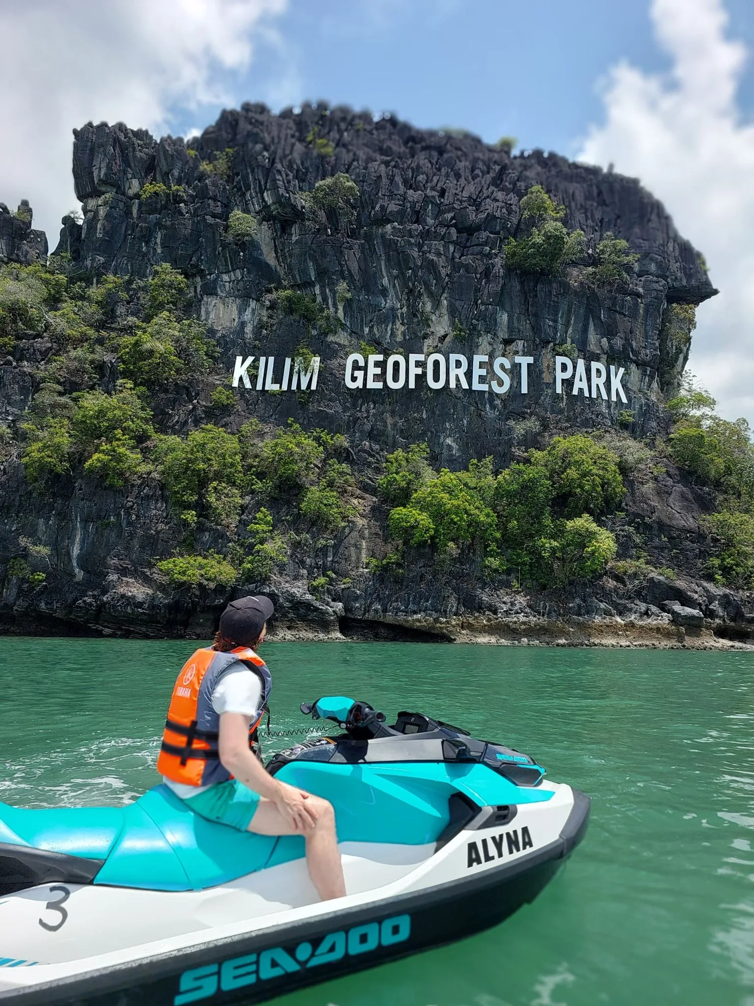 Jet ski rider at the limestone cliffs of Kilim Geoforest Park