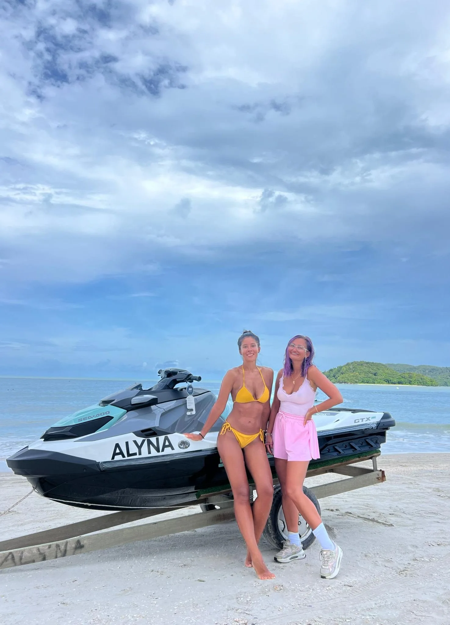Two guests beside a jet ski on the beach in Alyna’s gallery
