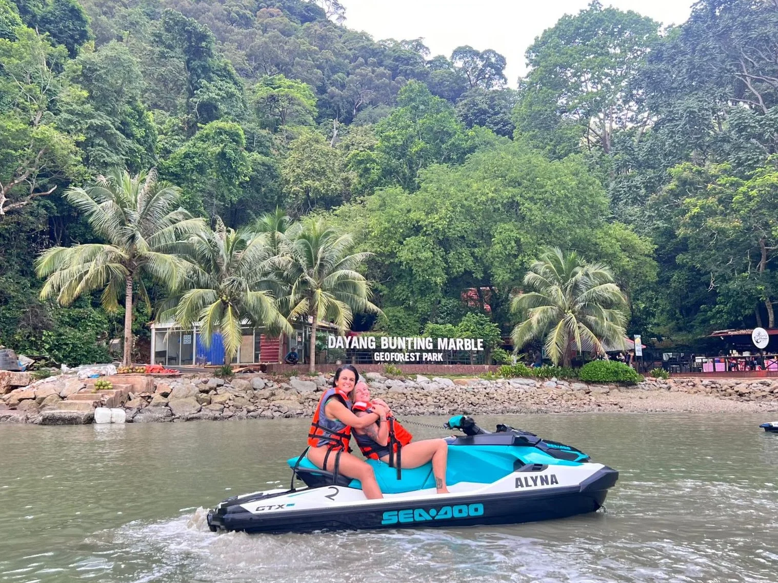 Alyna riders beside a wooded island landing